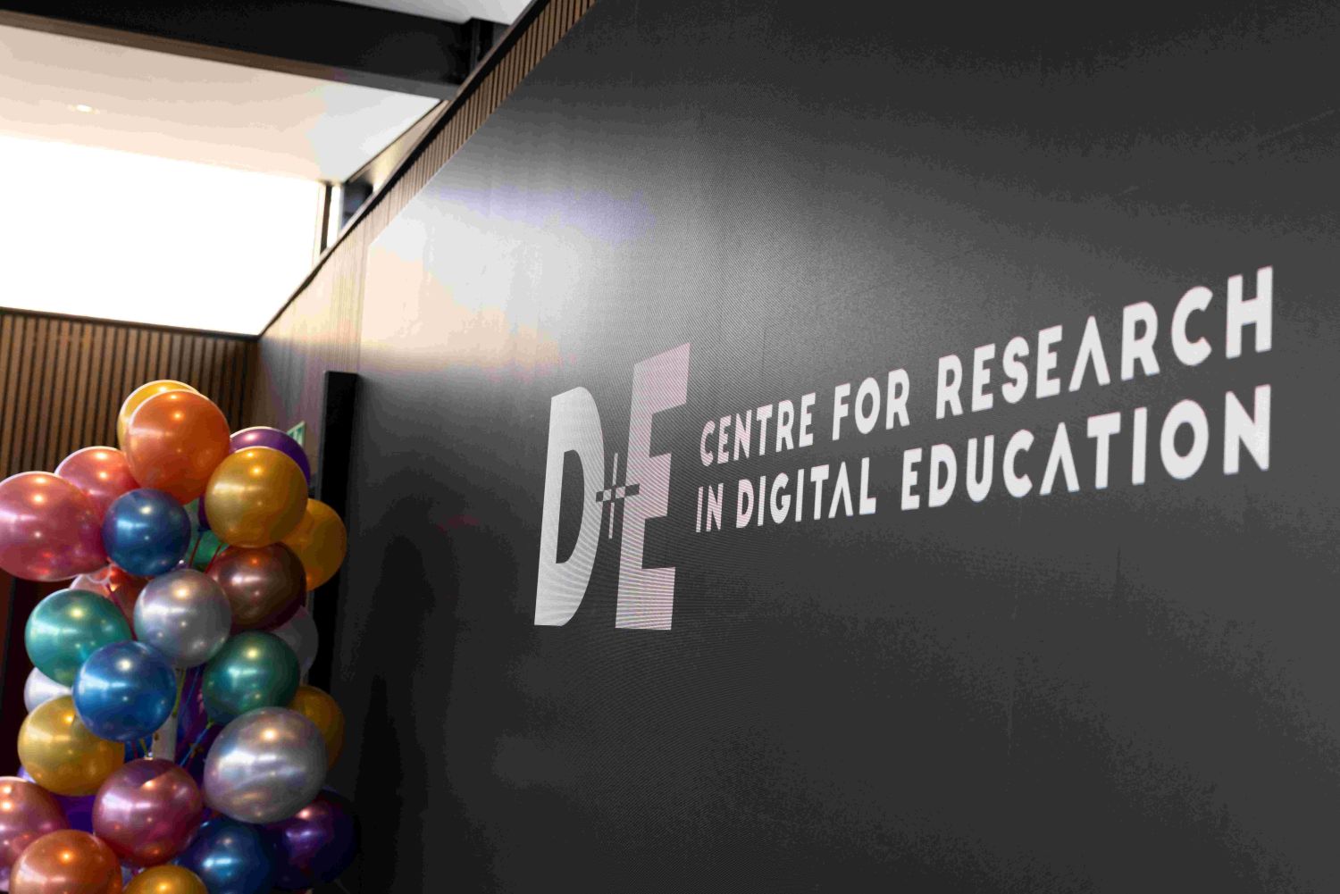 Picture of the party setting, with balloon tree and Digital Education logo